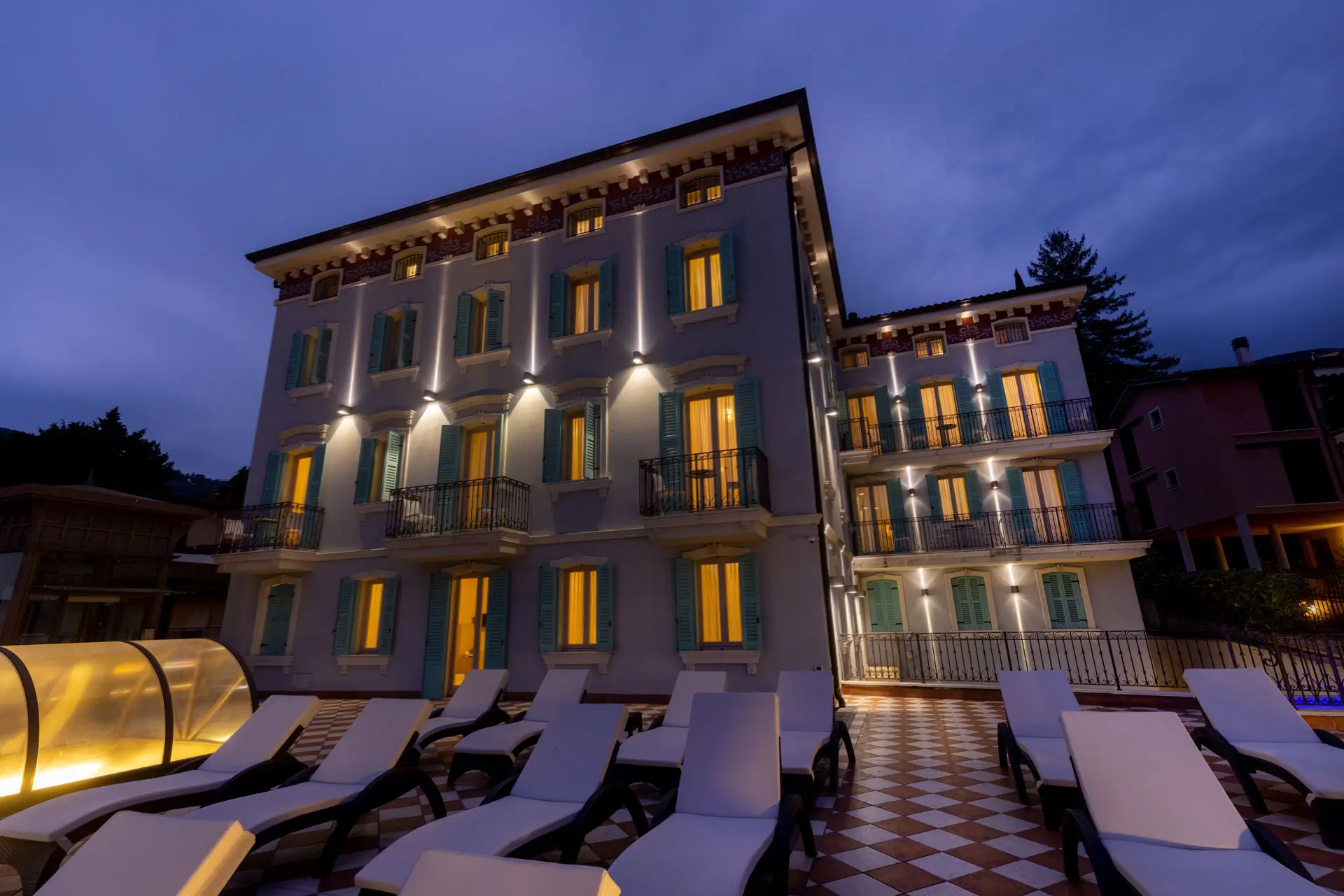 The facade of Gardone Palace at dusk